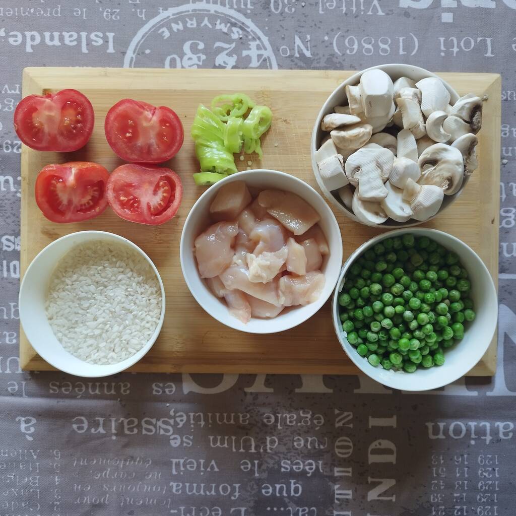 Ingredients for spicy chicken pilaf with peas: chicken breasts, tomato, green chilly bell pepper, mushrooms, rice, shown in a picture