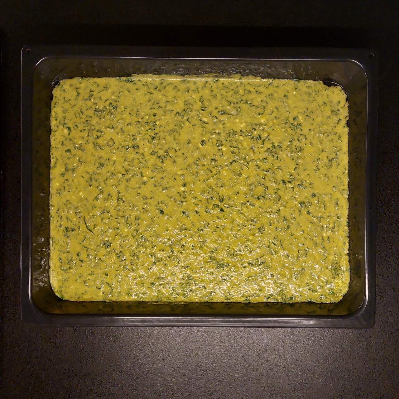 spinach cornbread with cottage cheese in a baking tray