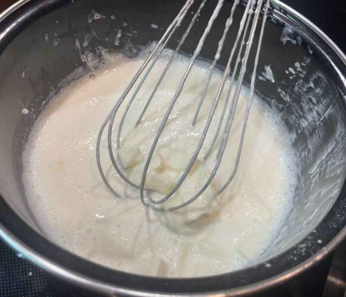 mixing cheese with a spatula in a bowl