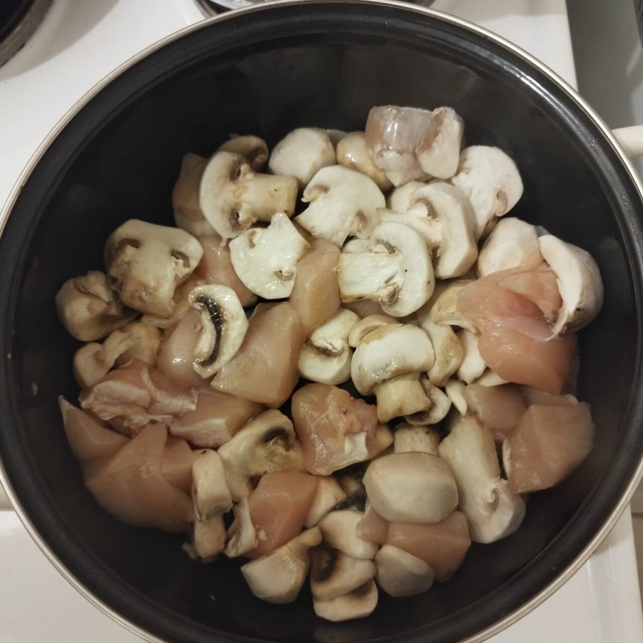 mushroom and chicken cooking in a cooking pot