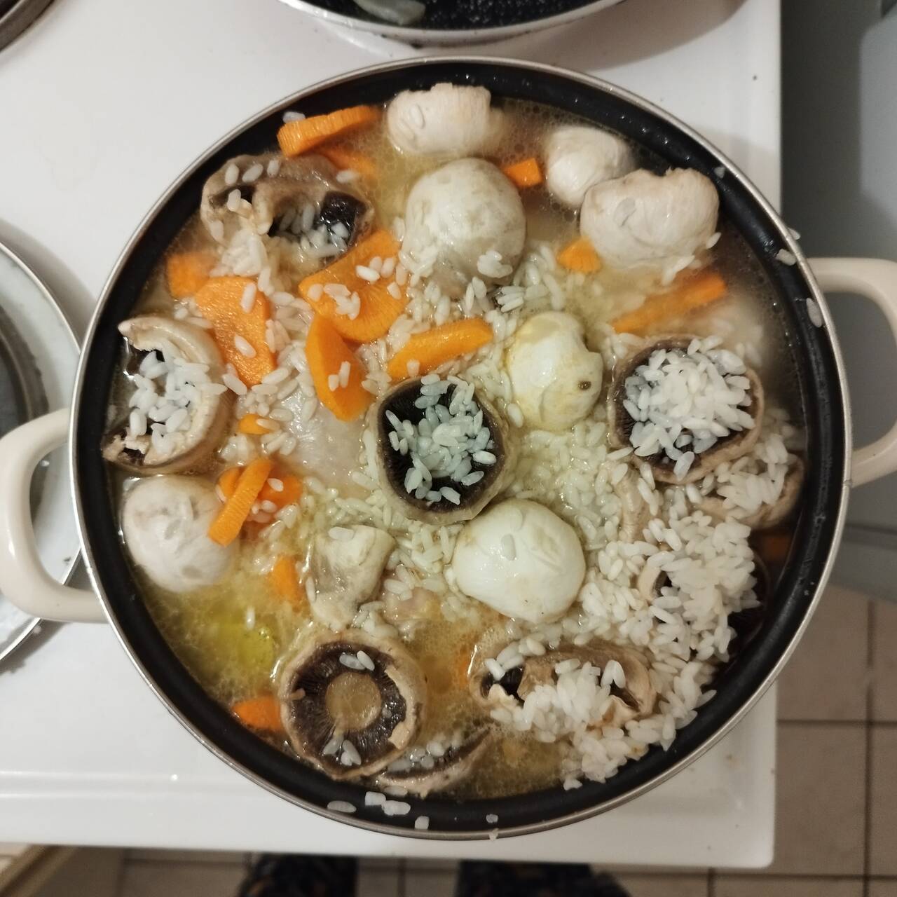 mushrooms, chicken drumsticks, carrots in a pot