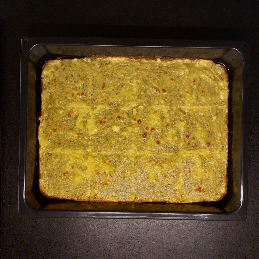 spinach cornbread with cottage cheese in a tray